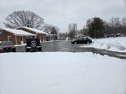 Parking lot plowed clear with snow banked along the edge